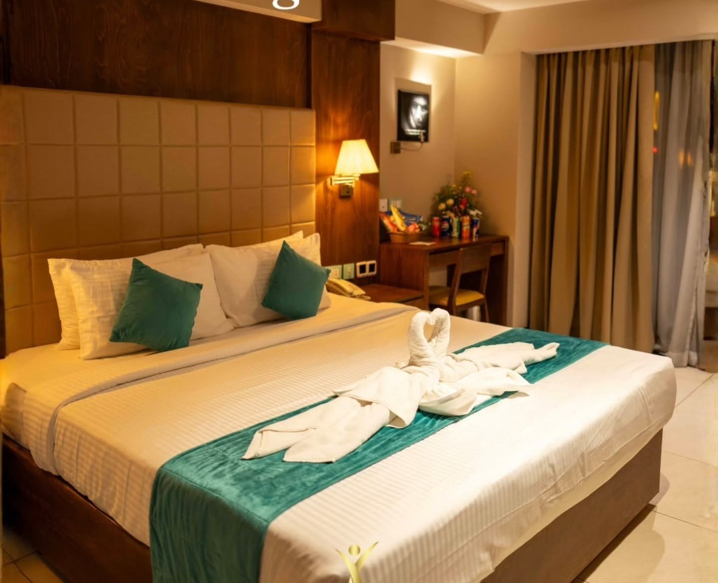 Yash International suite with king bed and teal accents